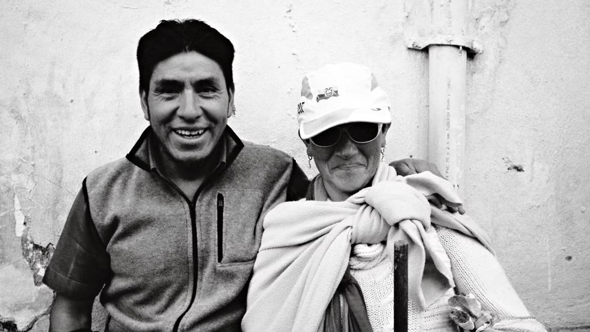 Black and white photo of a smiling couple in Quito, Ecuador, capturing a candid moment.